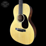 Acoustic guitar with a visible brand logo on a black background