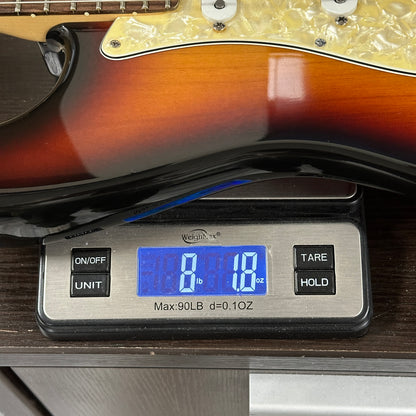 Guitar on a digital scale displaying weight