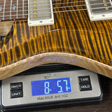 Guitar on a digital scale displaying weight
