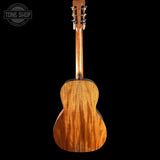 Wooden guitar back with 'Tone Shop' logo in the corner