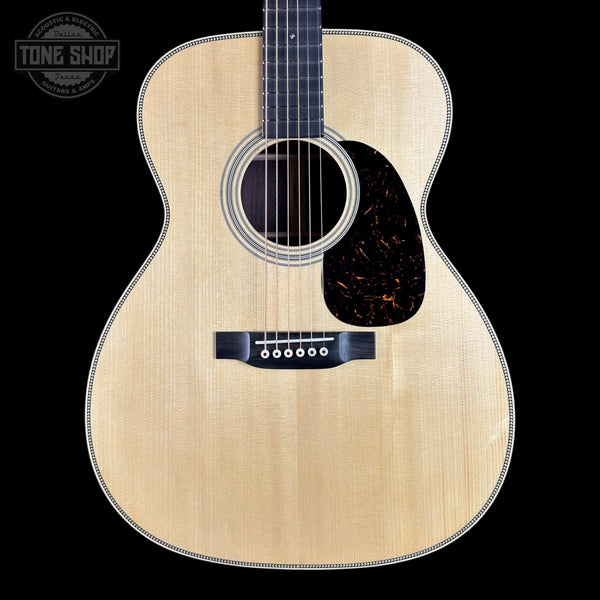Acoustic guitar with a visible brand logo in the corner