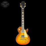 Electric guitar with a sunburst finish on a black background, featuring the Tone Shop logo.