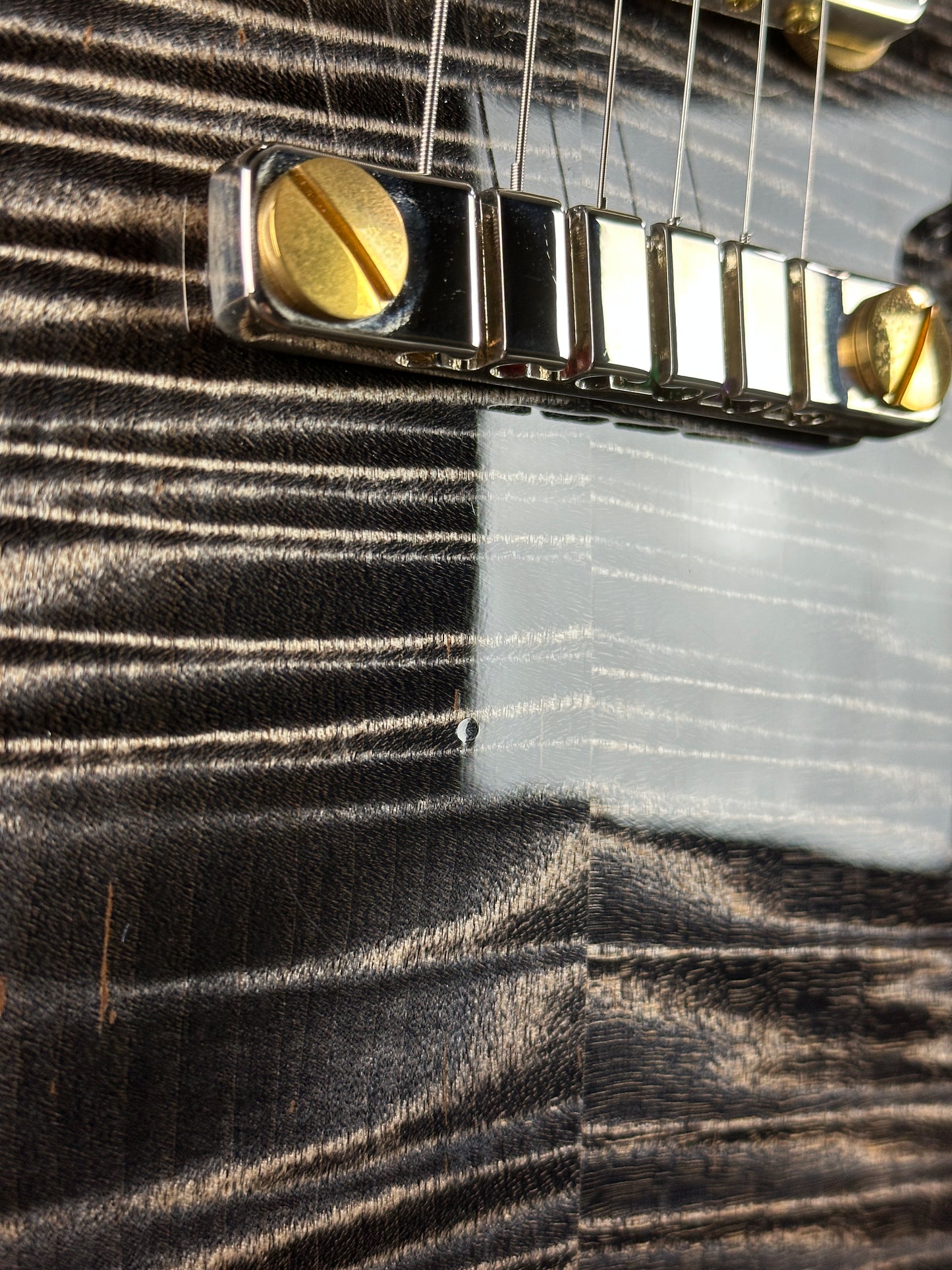 Ding below bridge of Used PRS McCarty 594 Singlecut 10-Top Charcoal Burst.