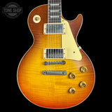 Electric guitar with a sunburst finish on a black background, featuring the Tone Shop logo.