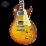 Electric guitar with a sunburst finish on a black background, featuring the Tone Shop logo.