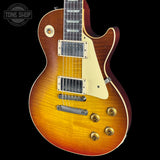 Gibson Les Paul electric guitar with a sunburst finish on a black background, featuring the Tone Shop logo.