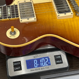 Electric guitar on a digital scale displaying weight
