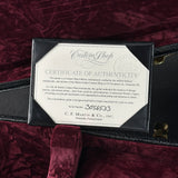 Certificate of authenticity for a C.F. Martin & Co. guitar on a maroon velvet surface
