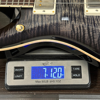 Guitar on a digital scale displaying weight
