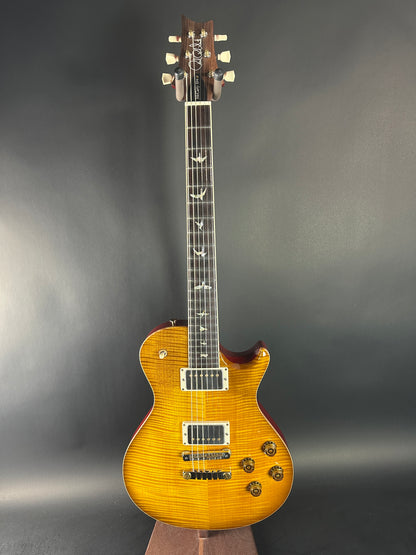 Electric guitar with a sunburst finish on a gray background