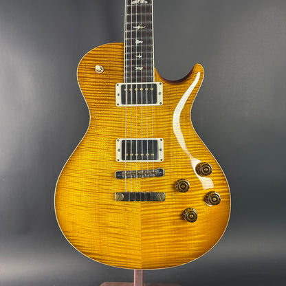 Yellow electric guitar on a gray background