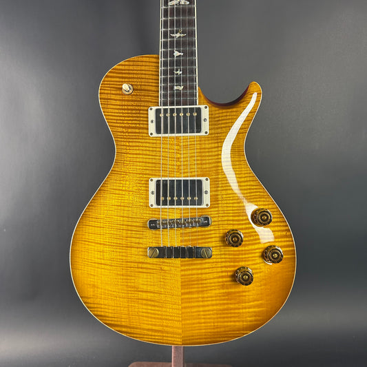 Yellow electric guitar on a gray background