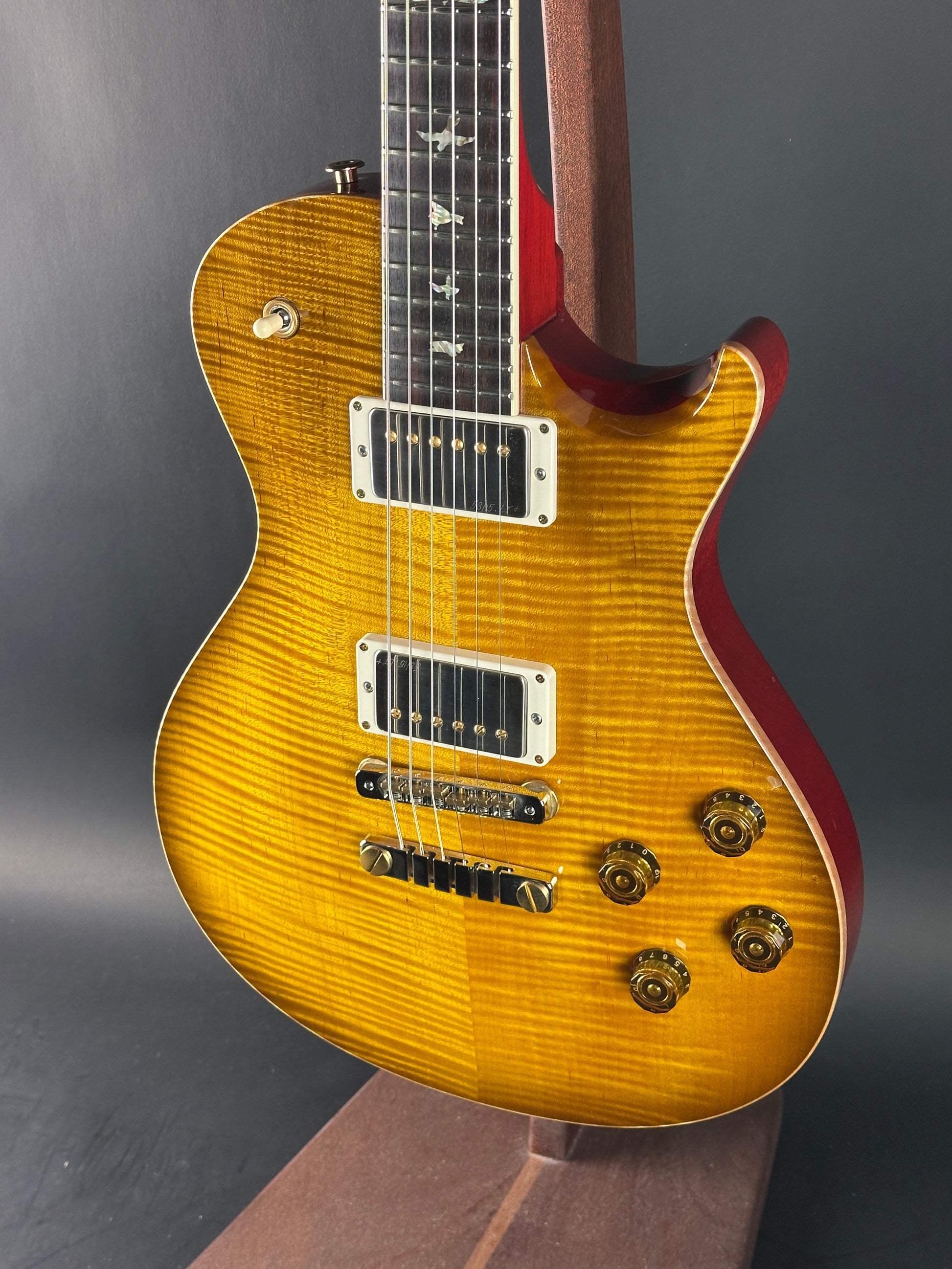 Close-up of a sunburst electric guitar on a dark background