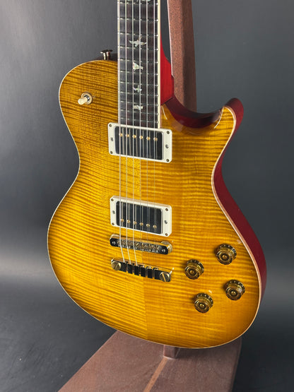 Close-up of a sunburst electric guitar on a dark background