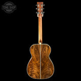 Wooden acoustic guitar on a black background with 'Tone Shop' logo.