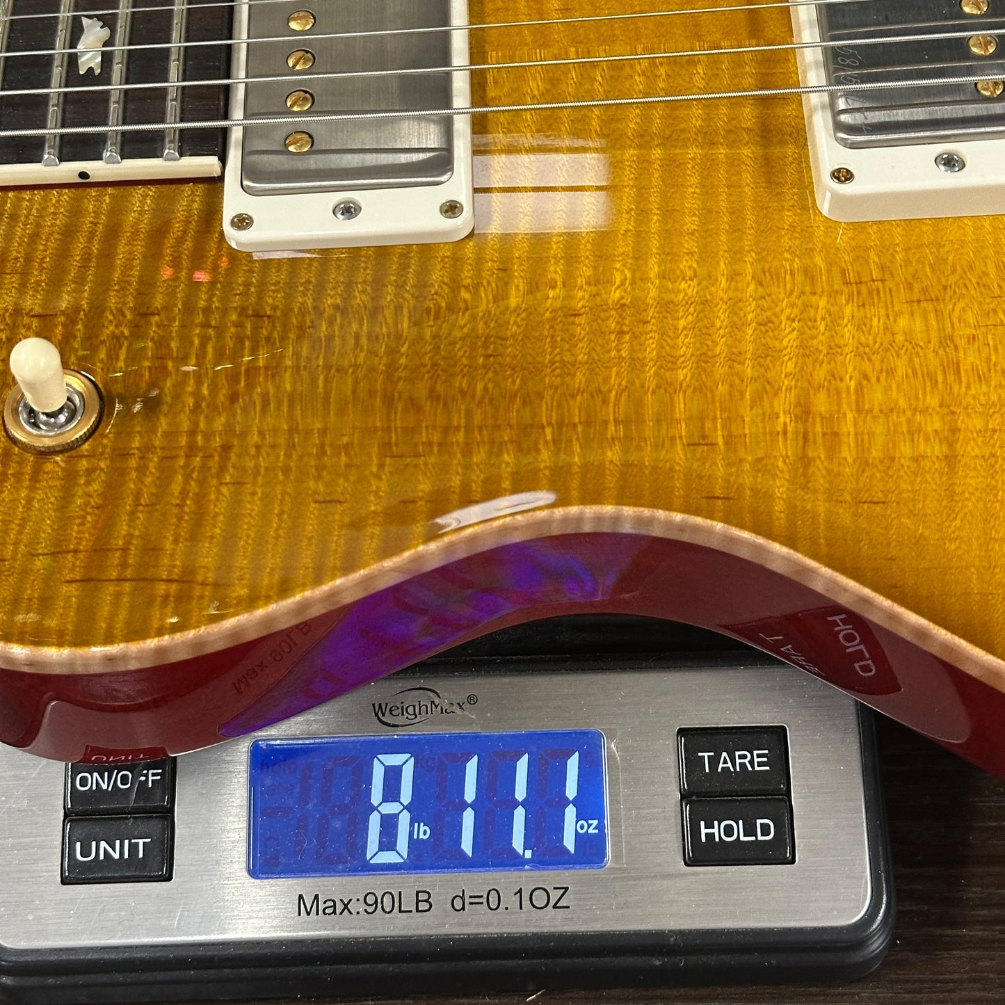 Used PRS McCarty 594 Singlecut 10-Top McCarty Sunburst on scale displaying weight.
