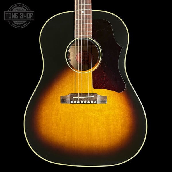 Acoustic guitar with a sunburst finish on a black background, featuring the Tone Shop logo.