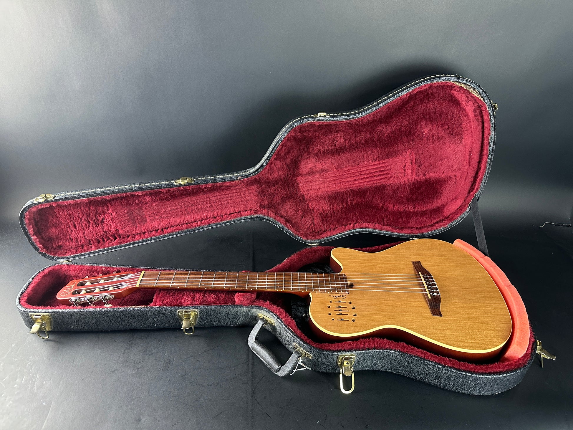 Acoustic guitar in a case on a gray background