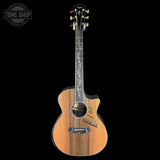 Taylor acoustic guitar on a black background with 'Tone Shop' logo.