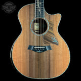 Acoustic guitar with a visible brand logo on a black background