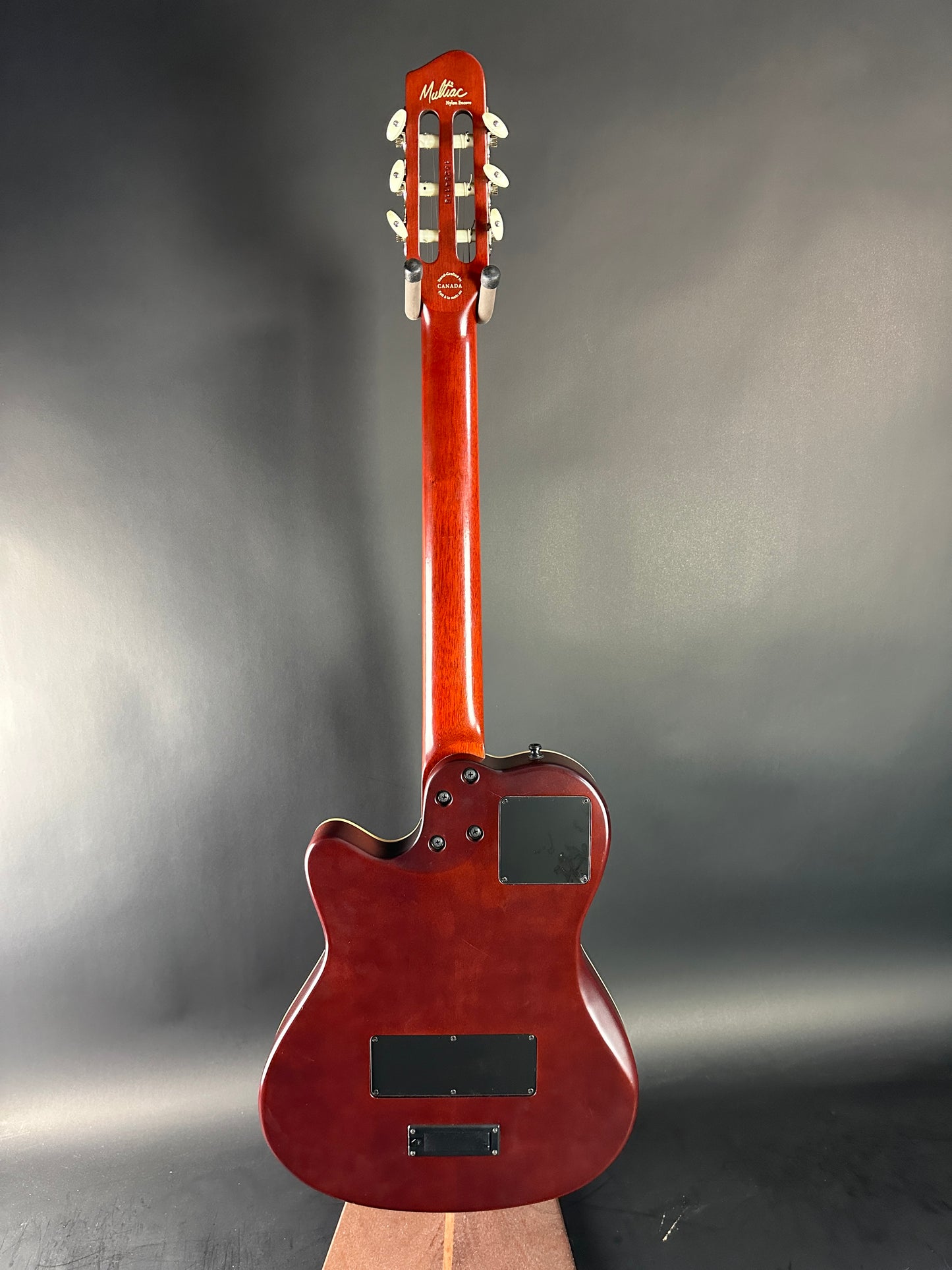 Red electric guitar on a gray background