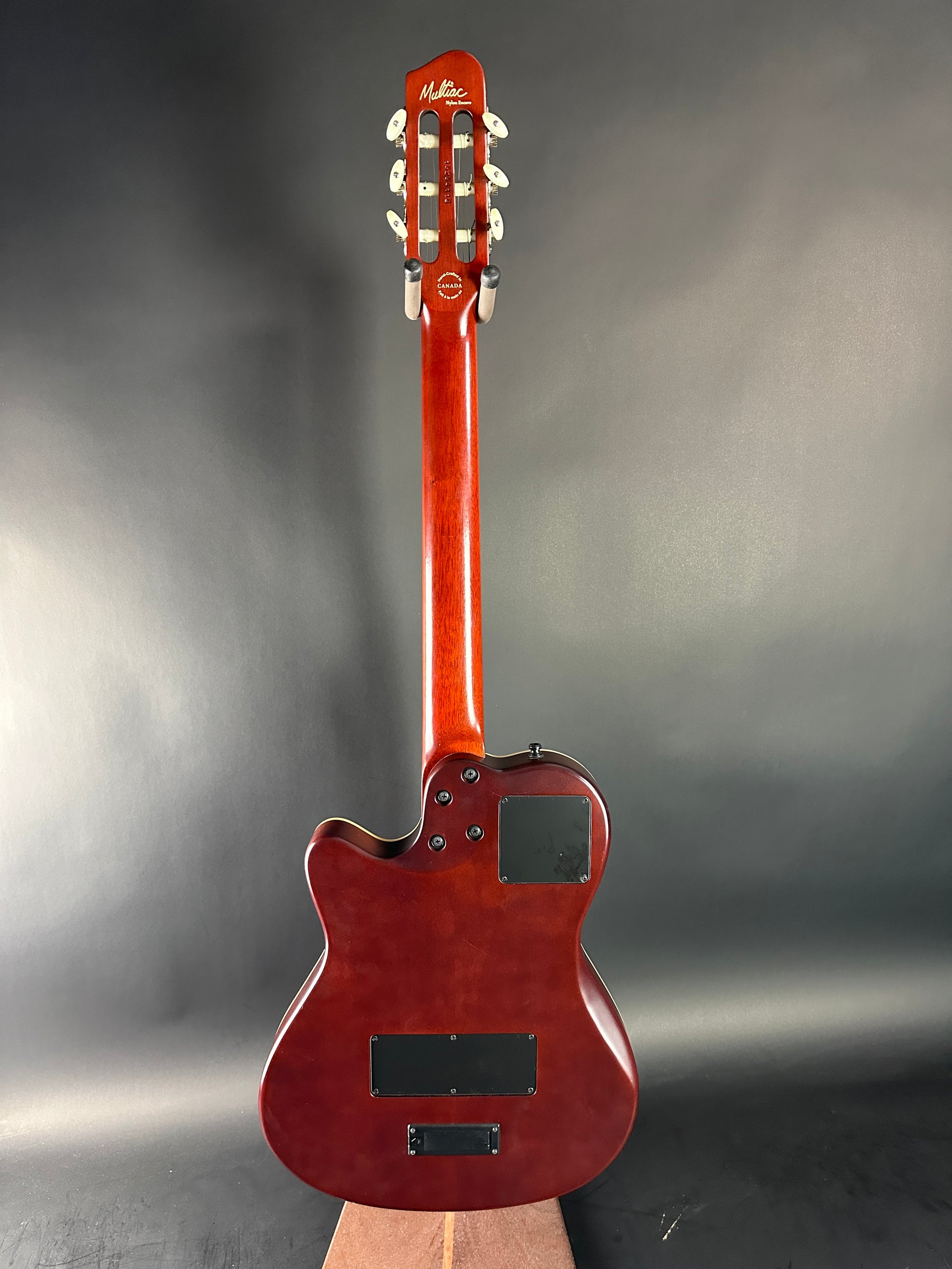 Red electric guitar on a gray background