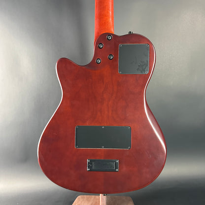 Back view of a red electric guitar on a gray background