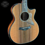 Acoustic guitar with a visible brand logo on a black background