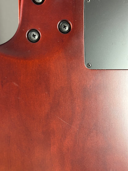 Close-up of a wooden surface with metal screws and a metallic plate.