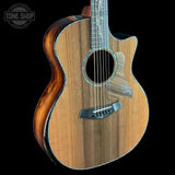 Acoustic guitar with a visible brand logo on a black background