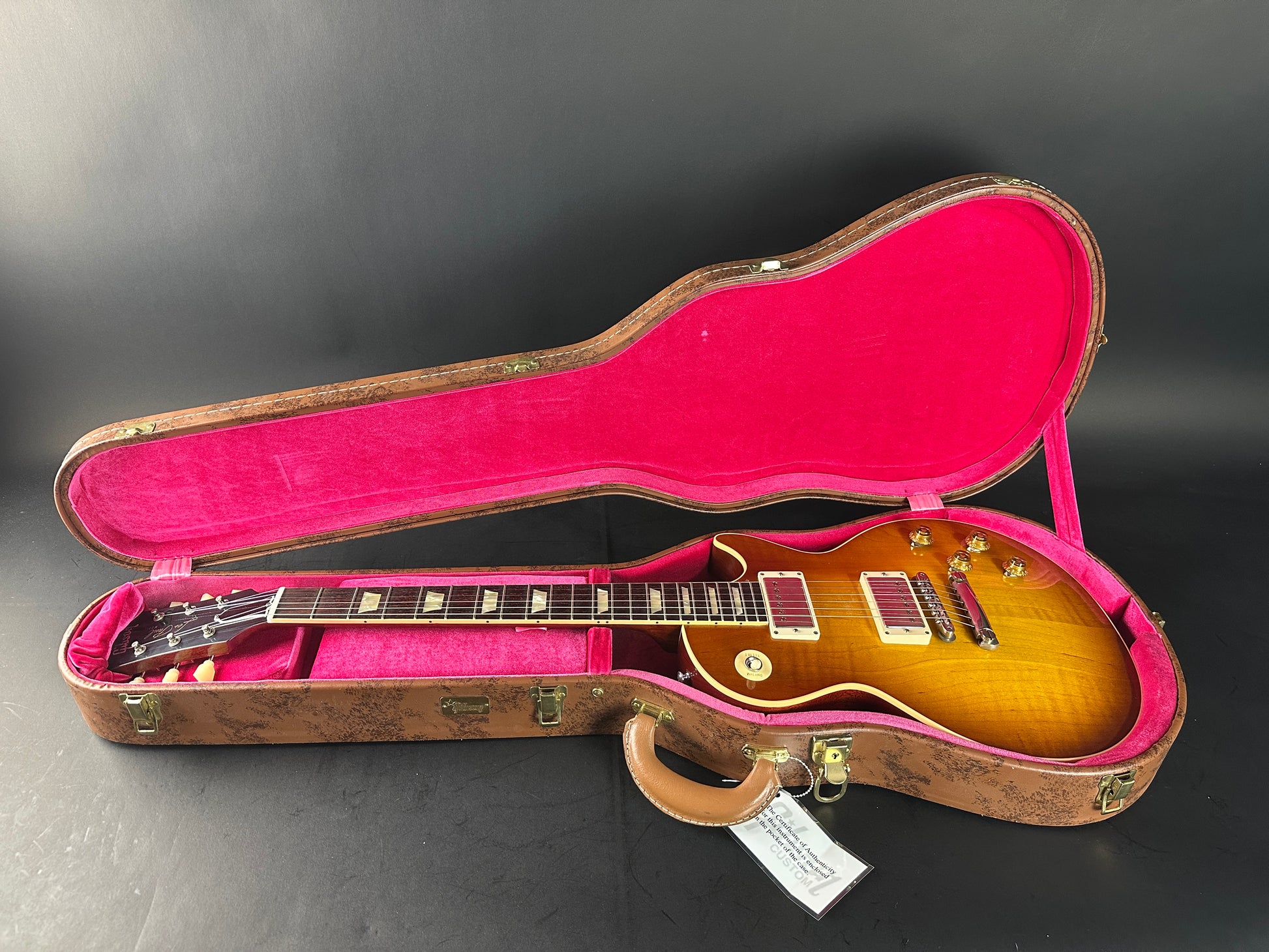 Gibson Les Paul guitar in a case on a dark background