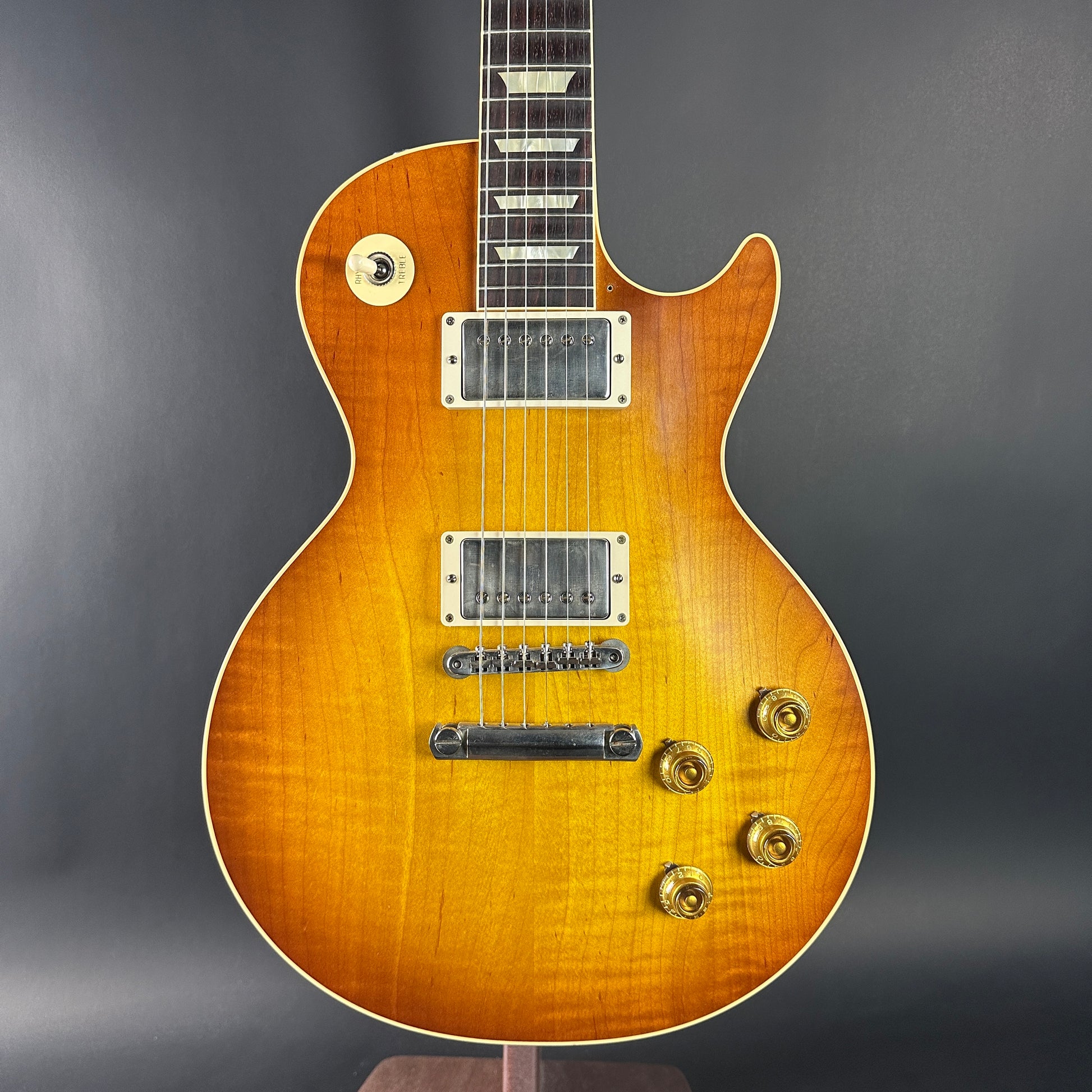 Electric guitar with a sunburst finish on a dark gray background