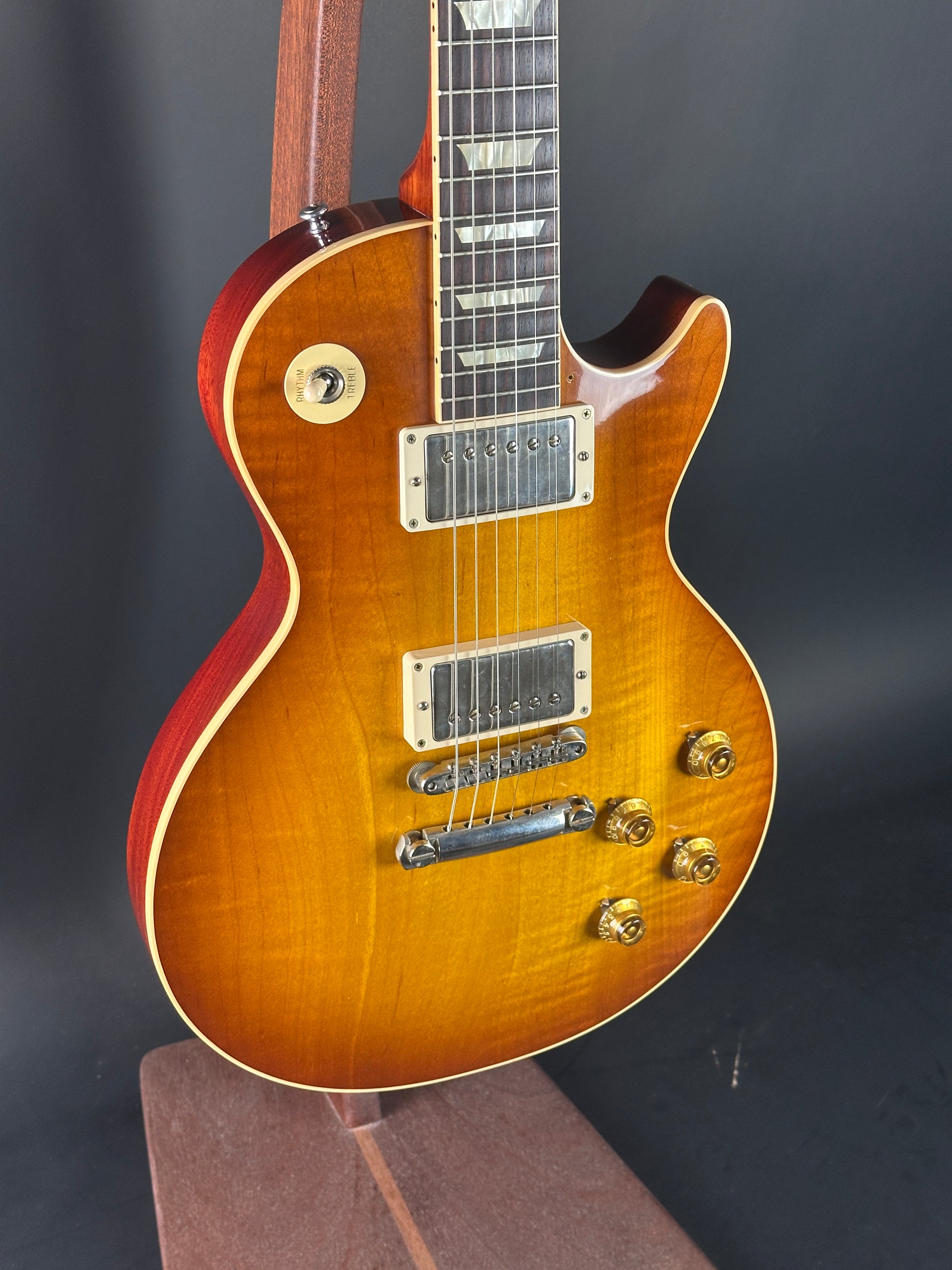 Electric guitar with a sunburst finish on a dark background