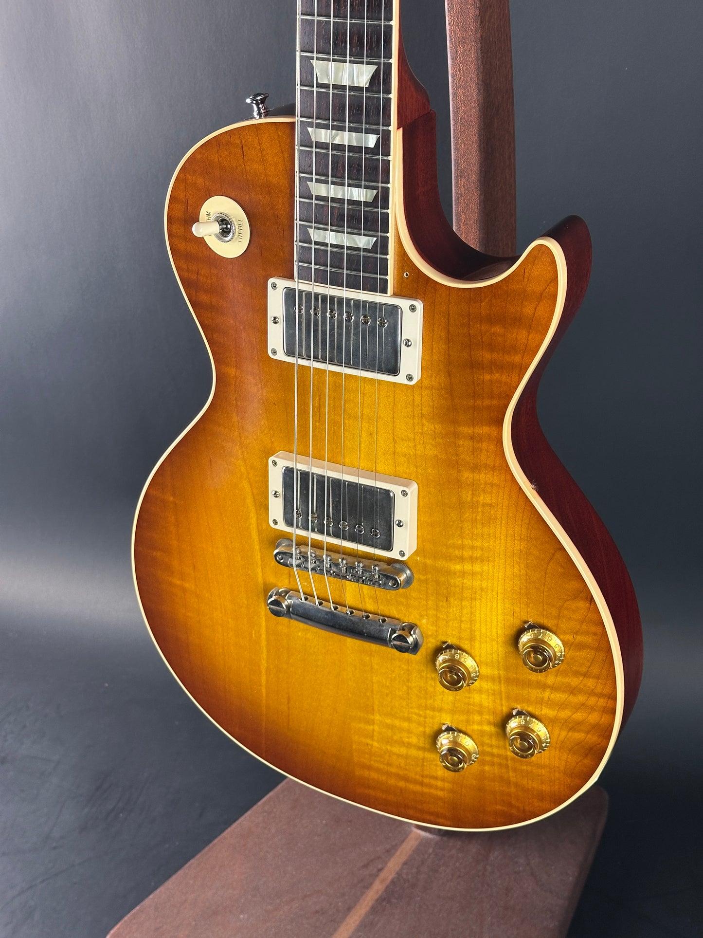 Gibson Les Paul guitar with a sunburst finish on a dark background