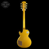 A gold-finish electric guitar shown from the back against a solid black background, with a Tone Shop watermark in the upper left corner.