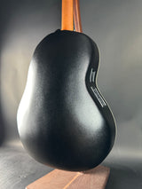 Black guitar pickguard on a guitar with a neutral background