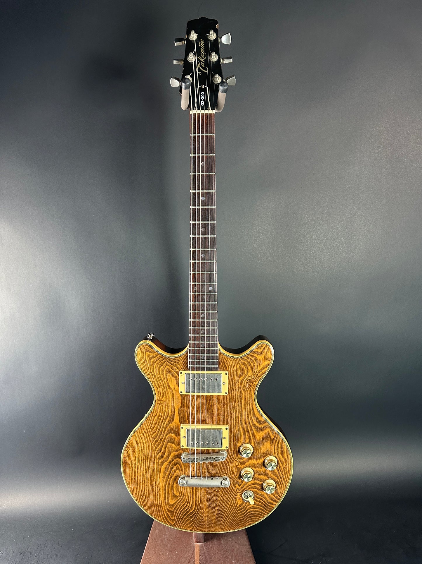 Wooden electric guitar on a dark gray background