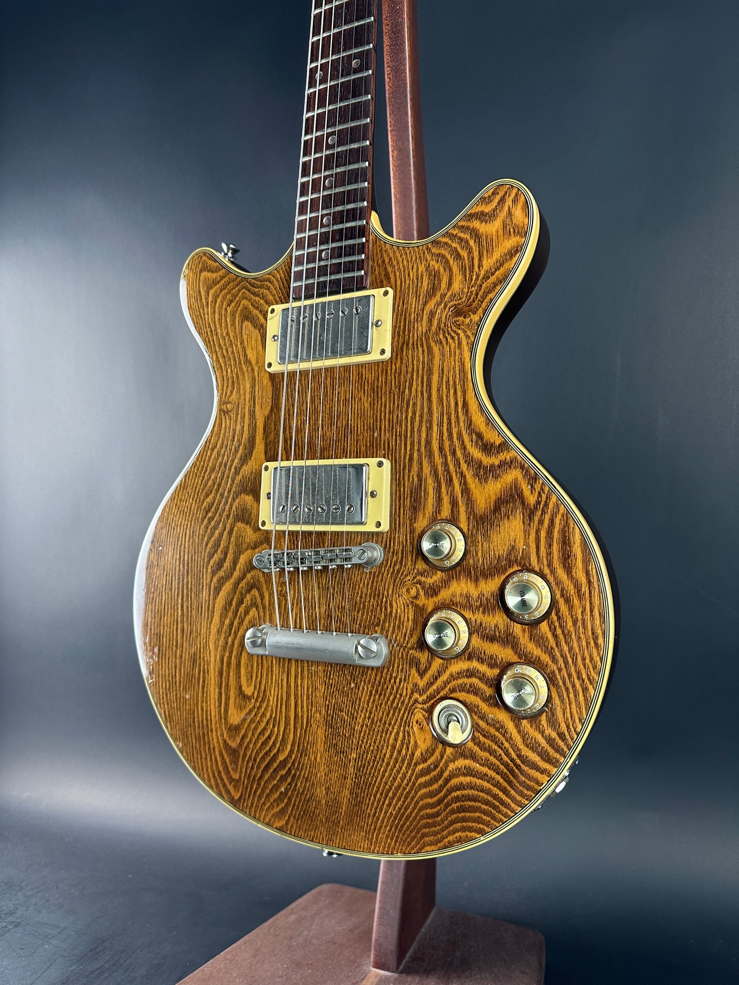 Wooden electric guitar with a dark background