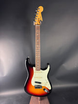 Electric guitar with a sunburst finish on a gray background