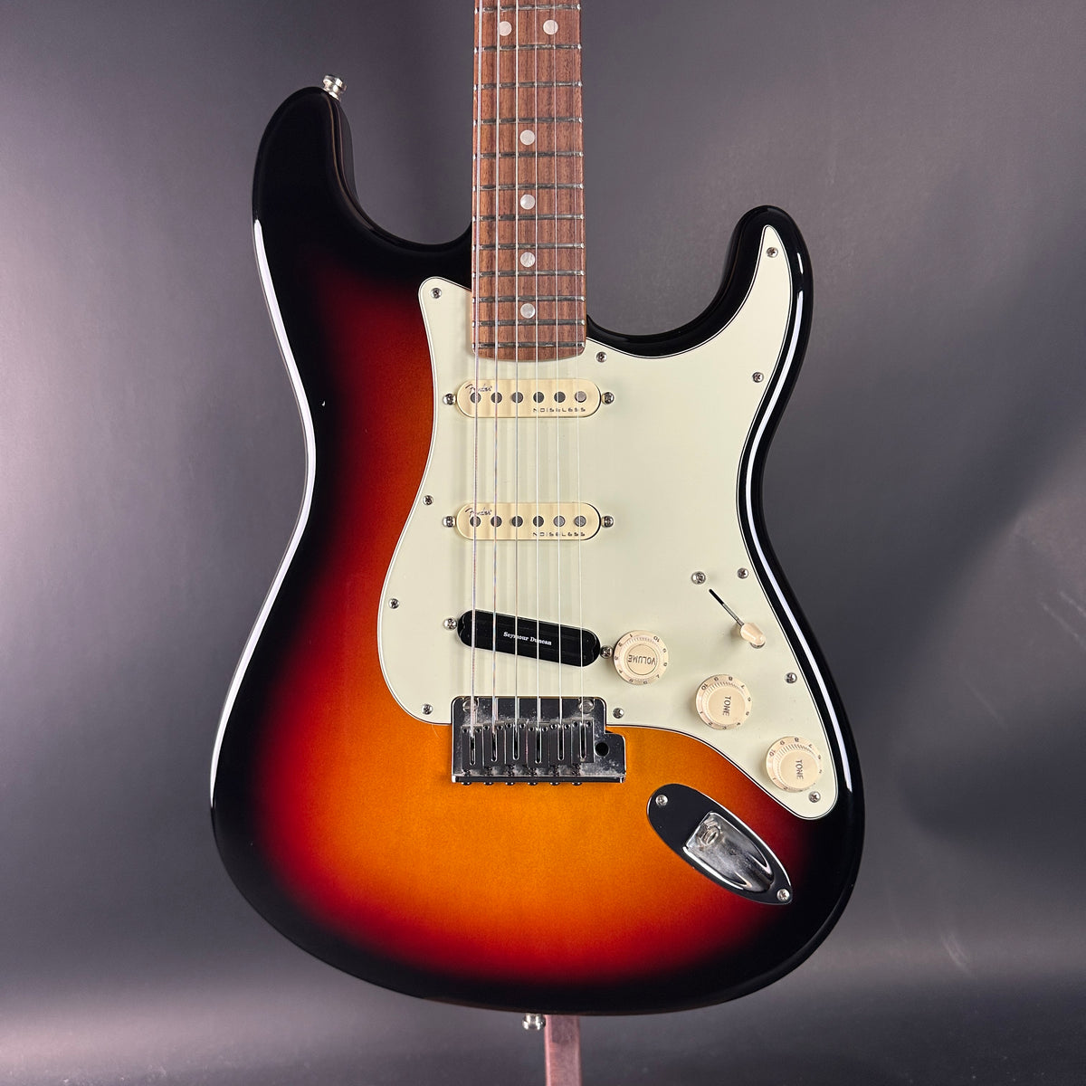 Electric guitar with a sunburst finish on a dark background