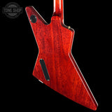 Close-up of the back of a red electric guitar body with a glossy flared shape, shown against a black background. A Tone Shop watermark is visible in the upper left corner.