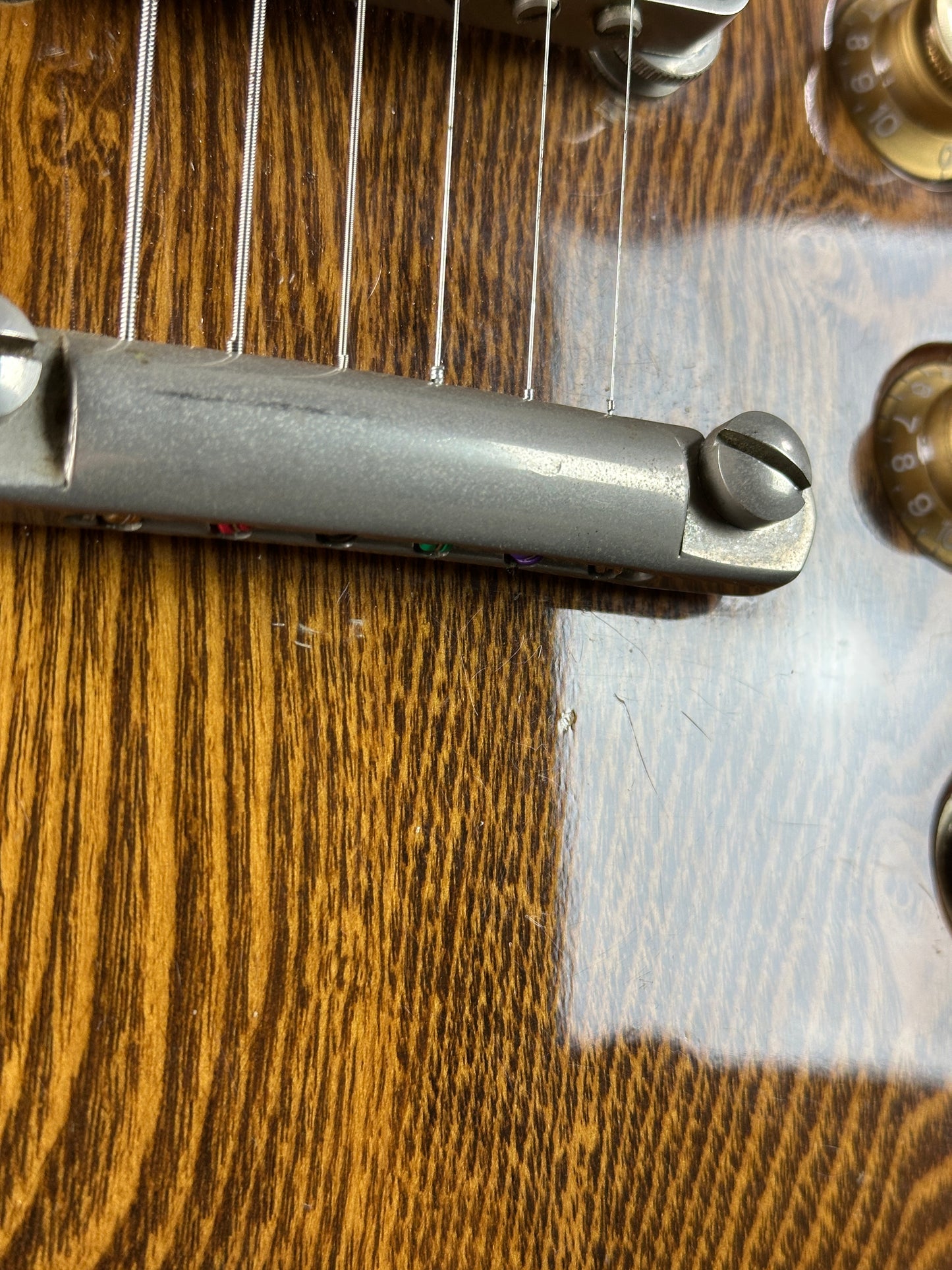 Close-up of a guitar's headstock with tuning pegs.