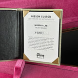 A Gibson Custom Certificate of Authenticity insert for Murphy Lab Heavy Aging, displayed inside an open Gibson Golden Era case lined with pink velvet.