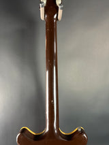Close-up of a guitar neck on a gray background