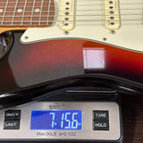 Used 2020 Fender American Ultra Stratocaster Ultraburst on scale displaying weight.