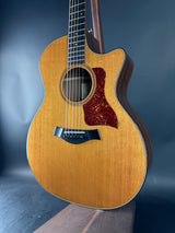 Acoustic guitar with a wooden finish on a dark background