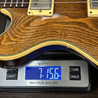 Guitar on a digital scale displaying weight