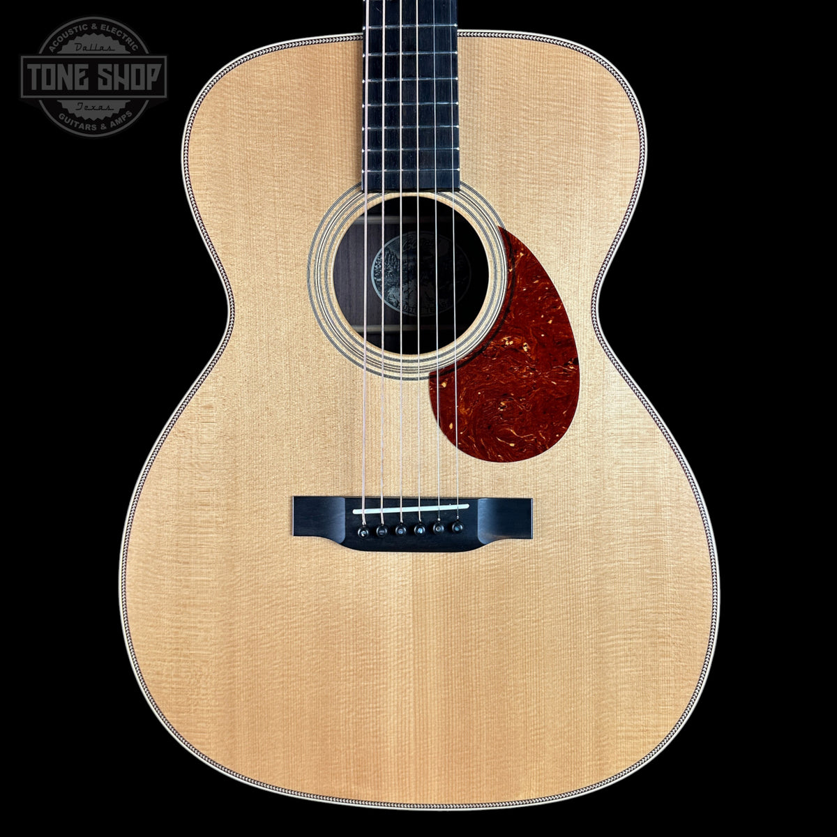 Acoustic guitar with a visible brand logo in the corner
