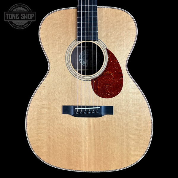 Acoustic guitar with a visible brand logo in the corner