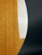 Close-up of a guitar's soundhole with a dark background